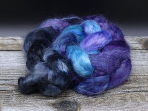 Kammzug aus Mohairfasern im Farbverlauf von schwarz über lila nach blau