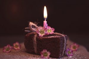 Brownie mit einzelner Kerze und rose Blüten